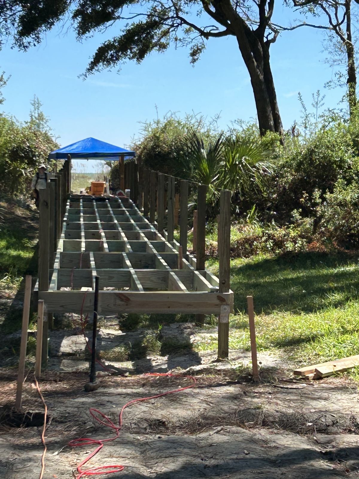 New deck framing on posts in a wooded backyard by Burson Construction, Bluffton SC